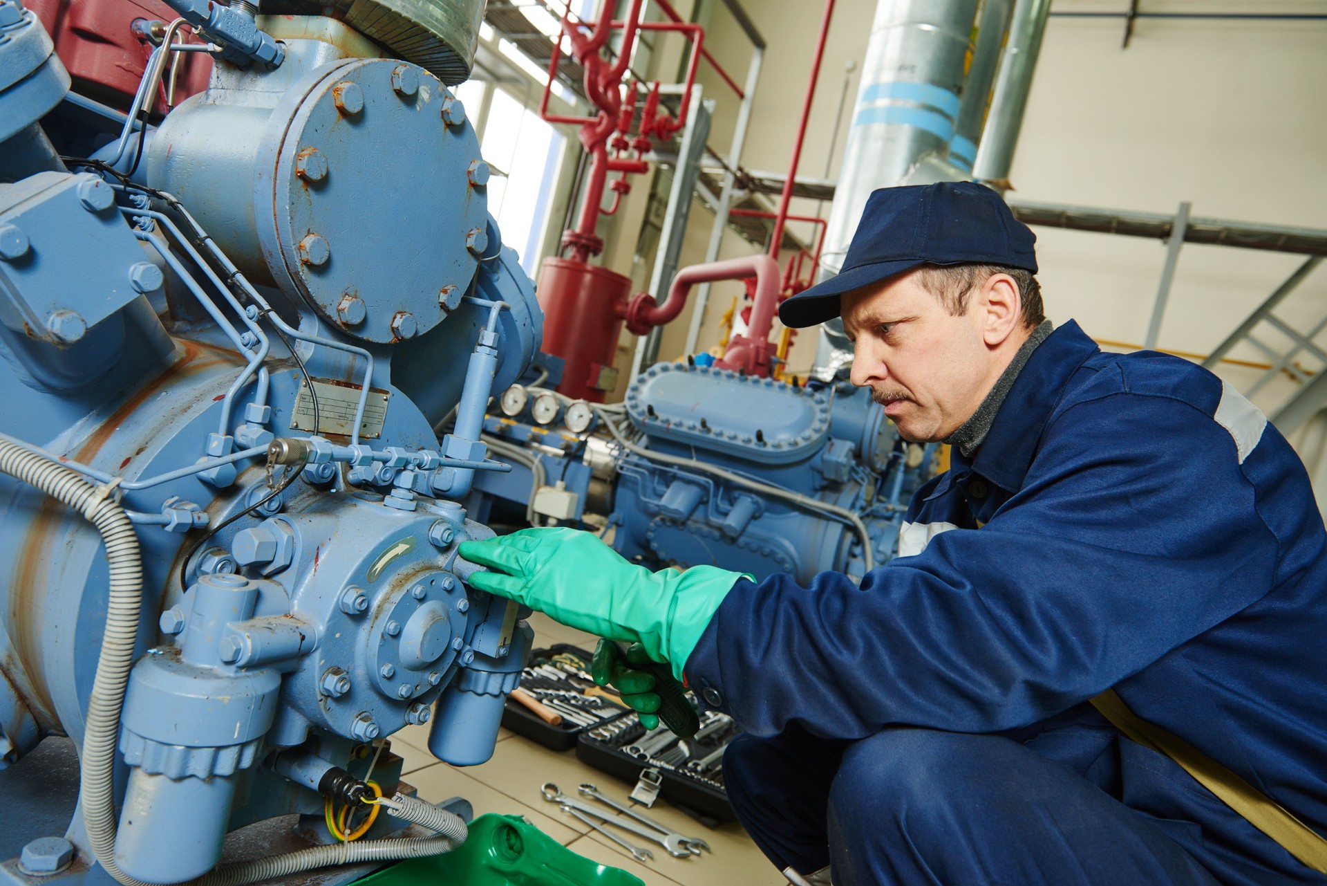 service worker at industrial compressor station