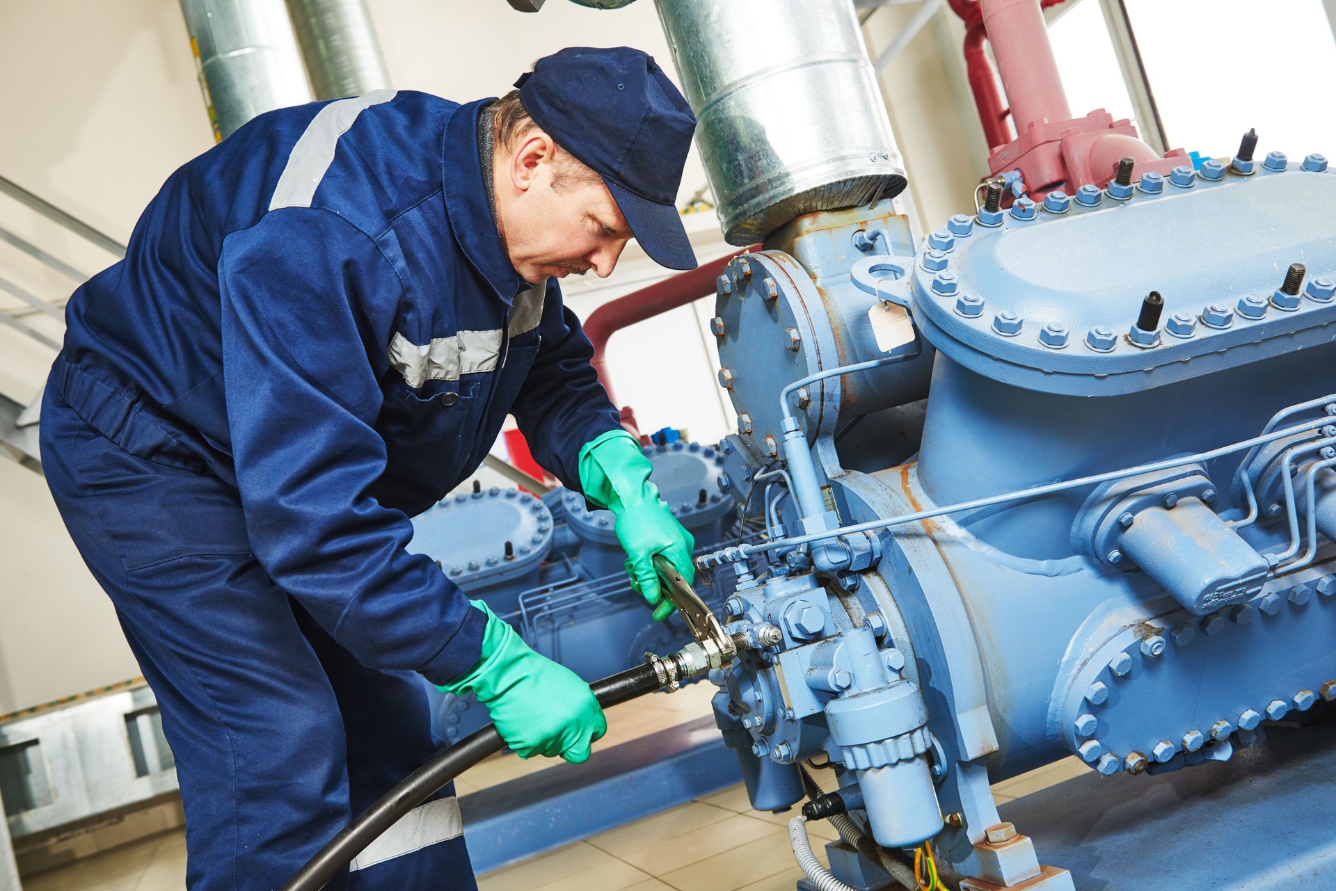 Service employee working on an industrial compressor station